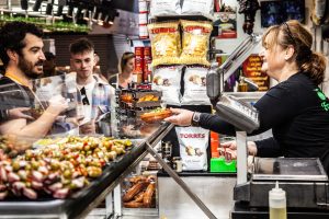 Ima handing out olives for tasting at La Boqueria