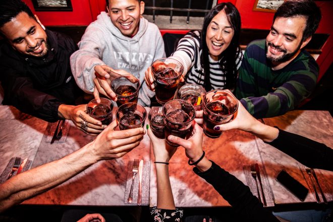 guests making a toast with vermouth