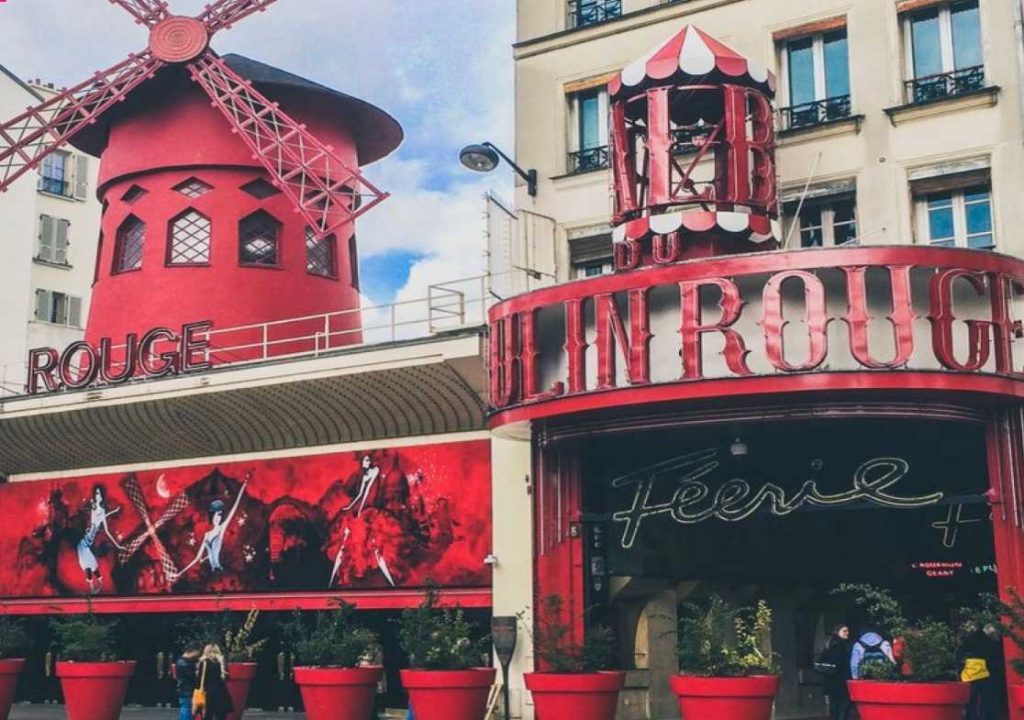 Red colored mill building with "Moulin Rouge" lettering.