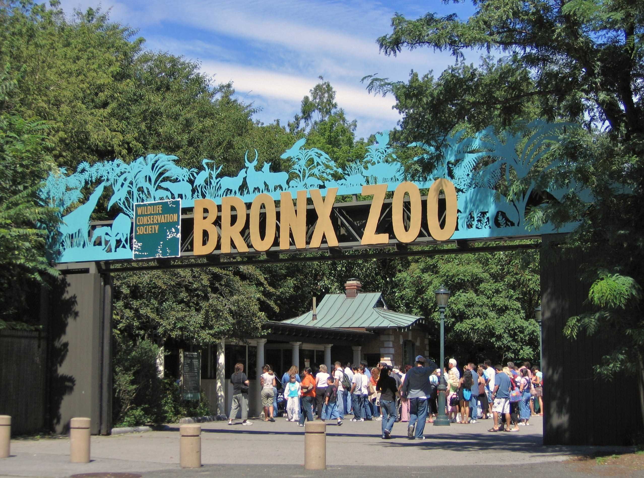 Bronx Zoo Sign, people standing underneath it