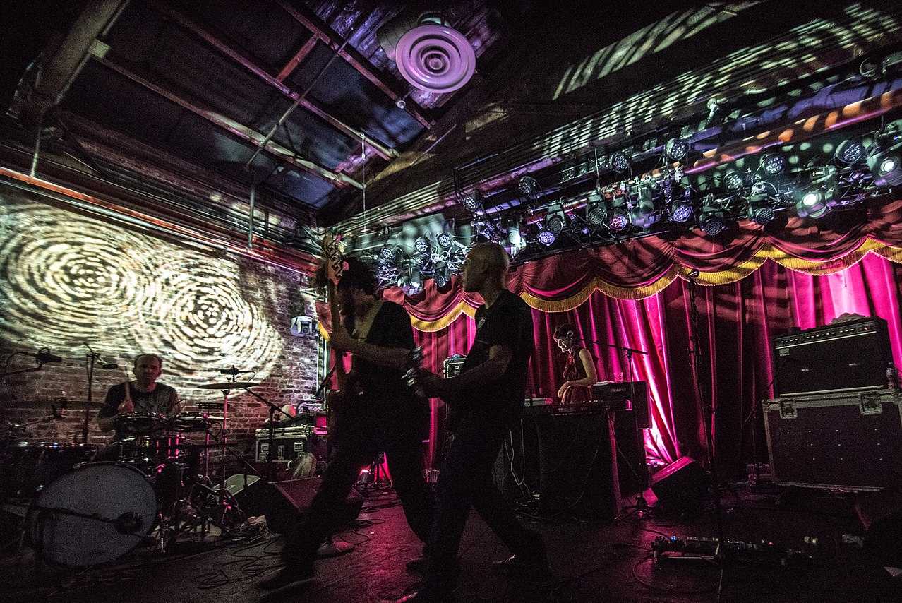 4 people on stage playing music