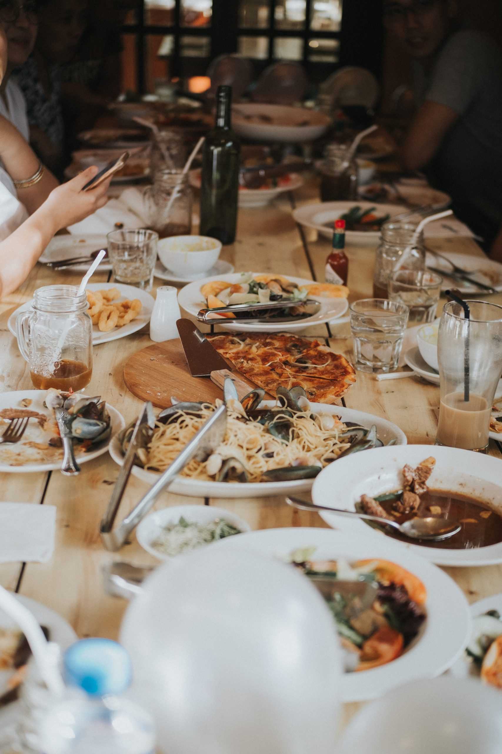 People dining on italian food at a big table