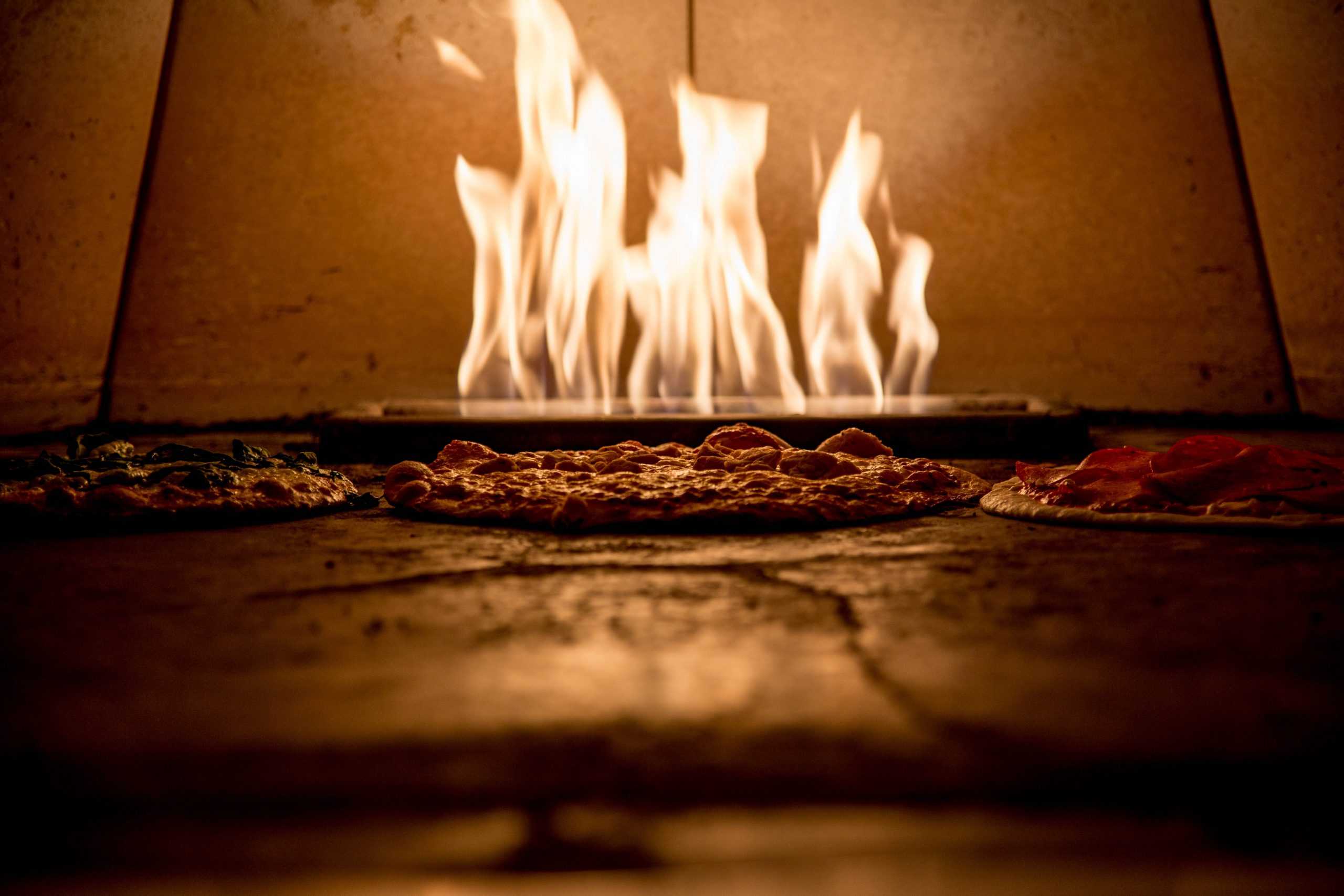 fire in an oven cooking pizza