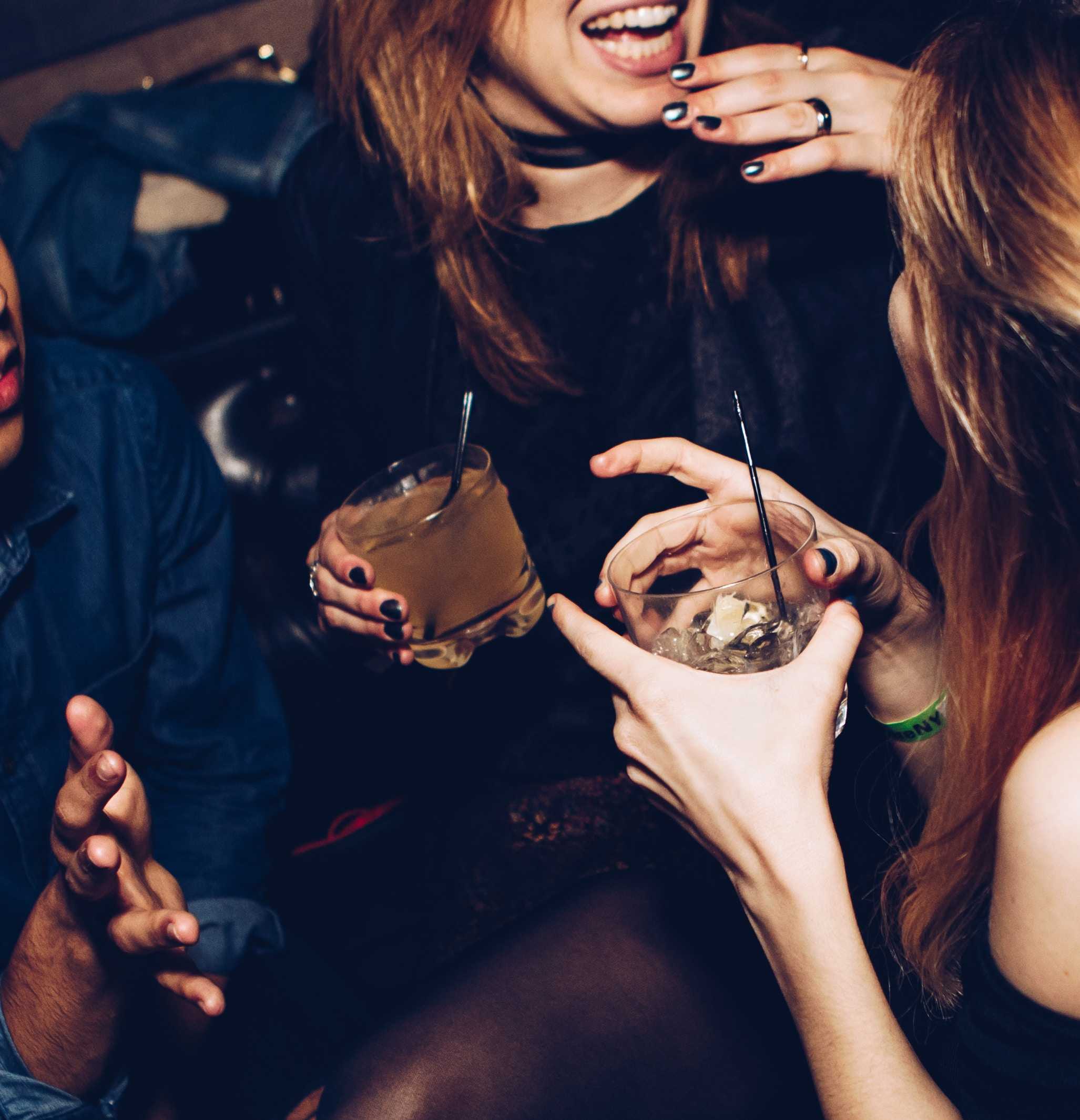 2 women talking and drinking