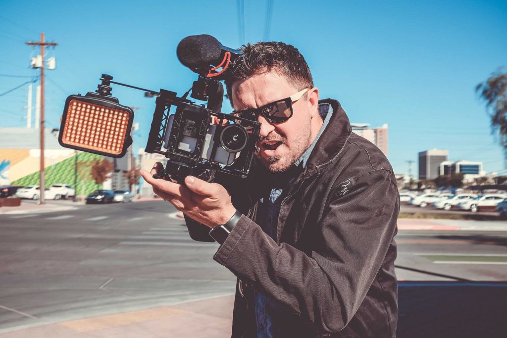 Man Filming in the middle of the street