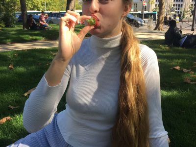 Lovely girl enjoying a picnic in the grass in Paris