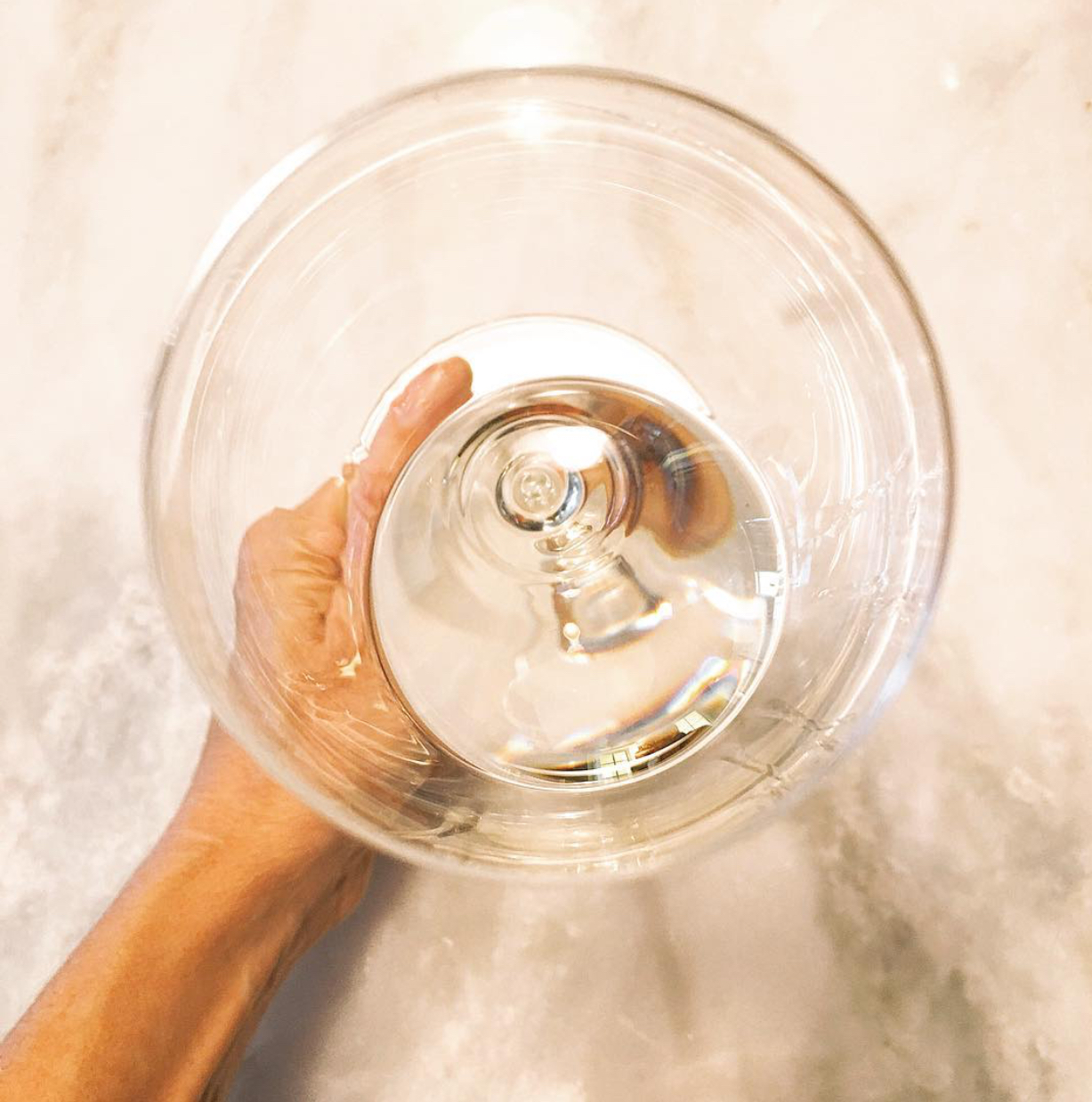 Wine glass with white wine on a marble table