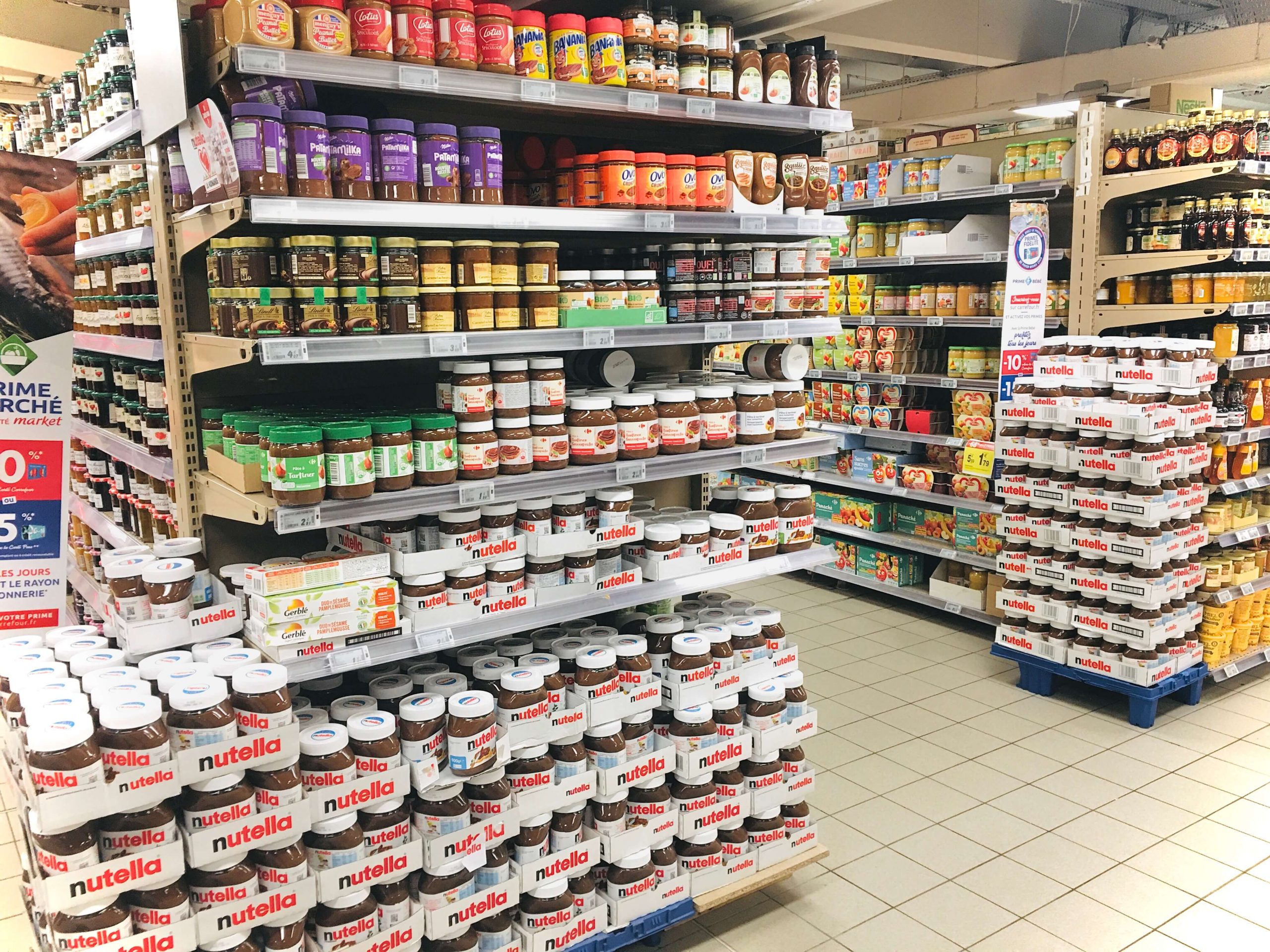 Many jars of pate a tartiner on shelves at the grocery store
