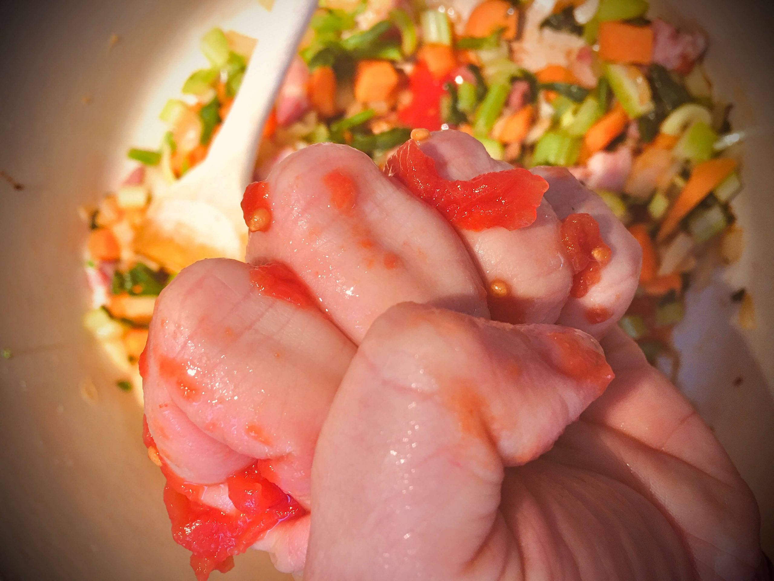 Hand crushing a tomato