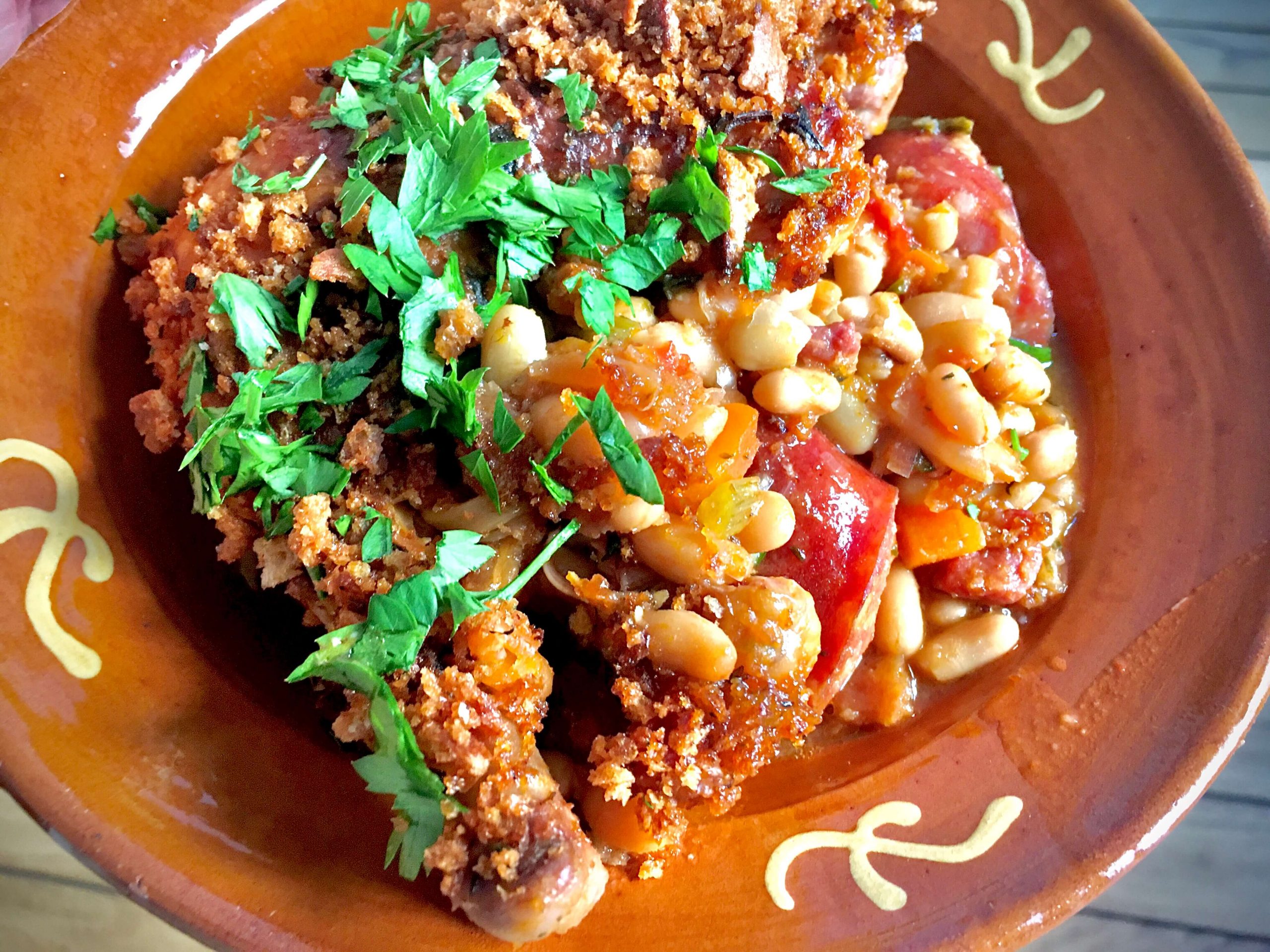 A full bowl of Cassoulet with parsley garnish