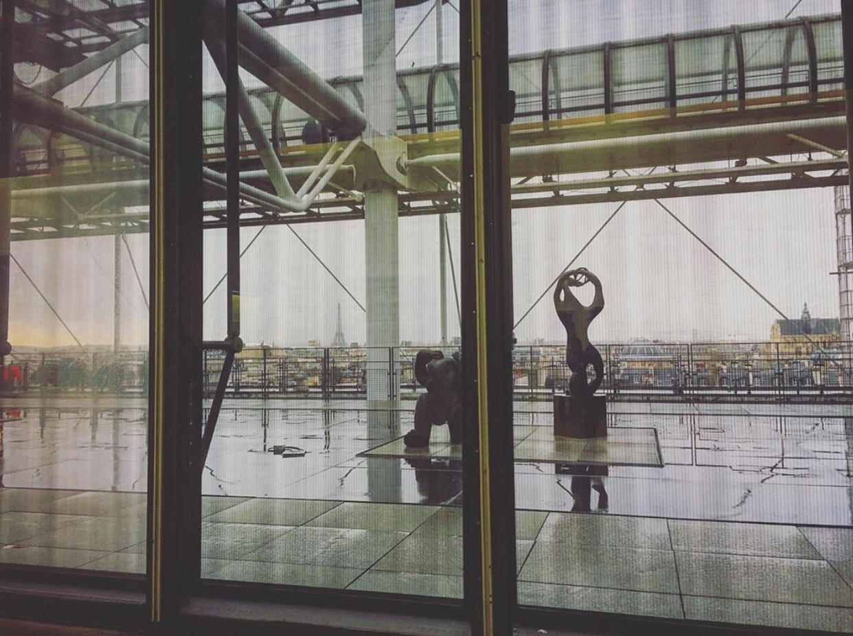 Looking out the wondow in Pompidou museum with a view of outdoor sculpture and the city