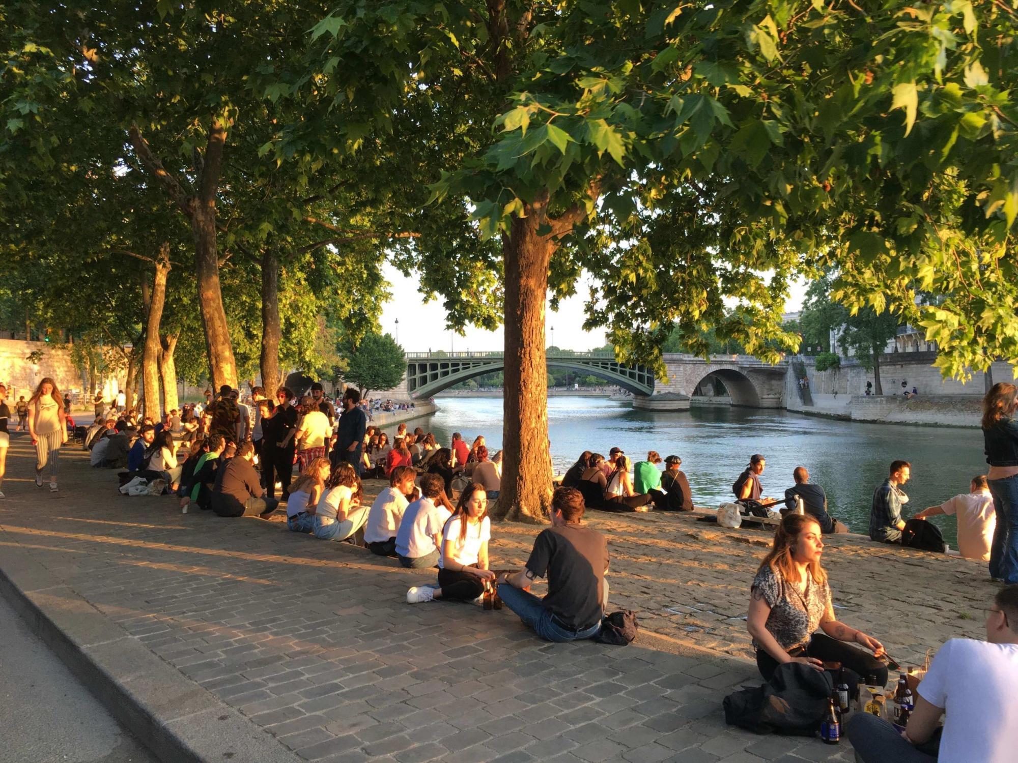 Parisians gathering on the banks of the Seine