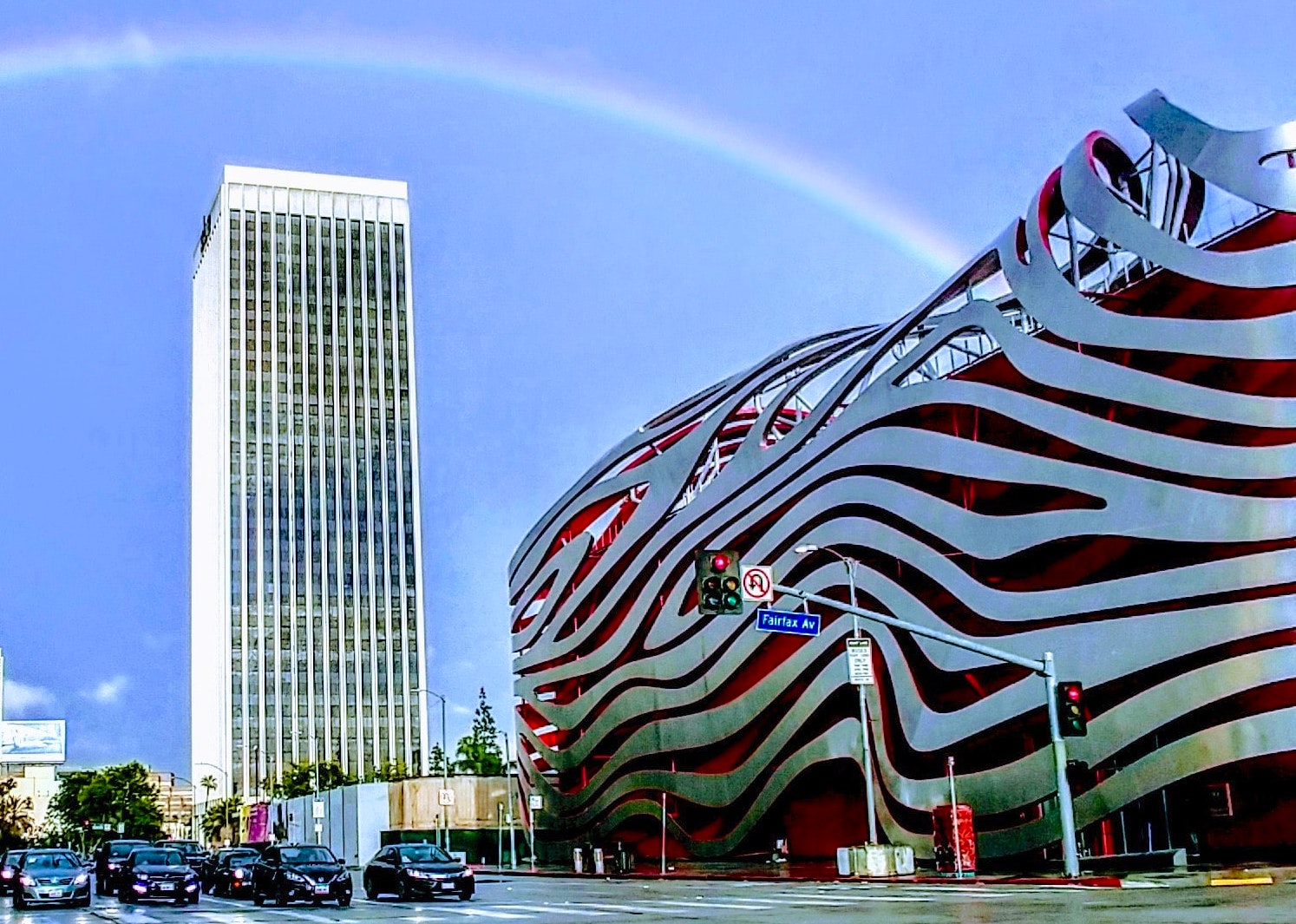 Exterior of the Peterson Automotive Museum under a rainbow