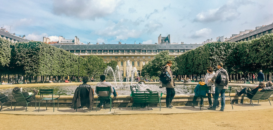 Loungers enjoying the fountain at Jardin du Palais Royal, located in a 17th century palace