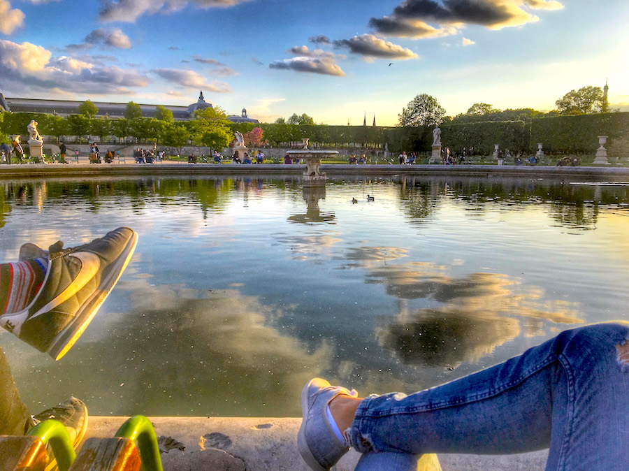Sitting on the green chairs at a fountain in Tuileries Garden, the oldest garden in Paris