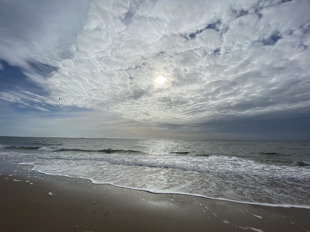 Brighton Beach in Brooklyn with cloud cover and sun