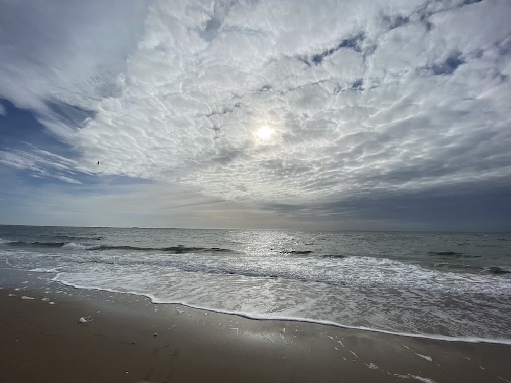 Brighton Beach in Brooklyn with cloud cover and sun