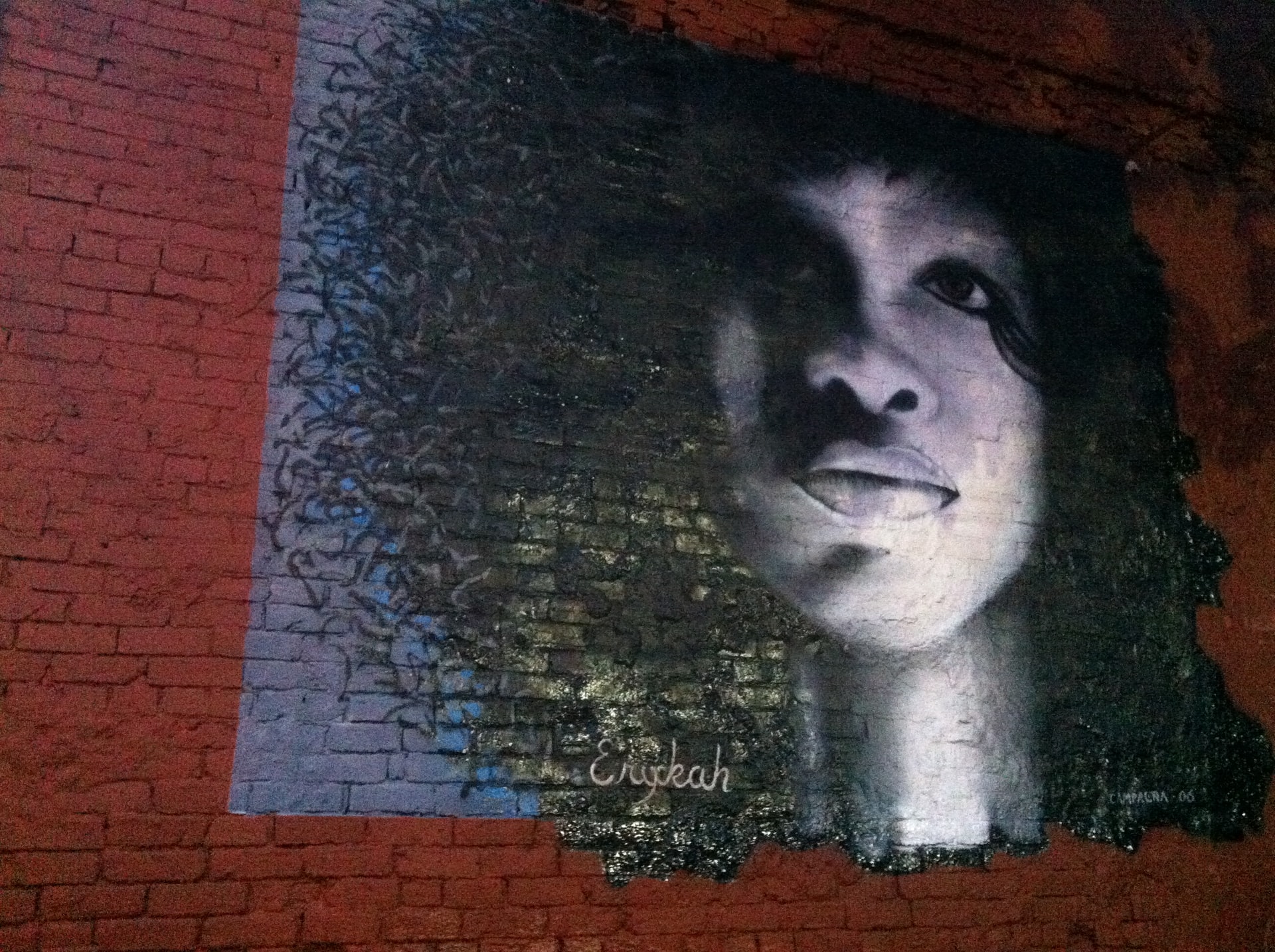 Mural of woman's face painted on a brick wall in Deep Ellum Texas