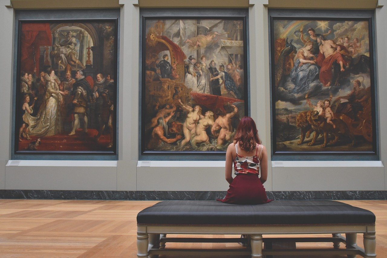 woman looking at art in the Louvre