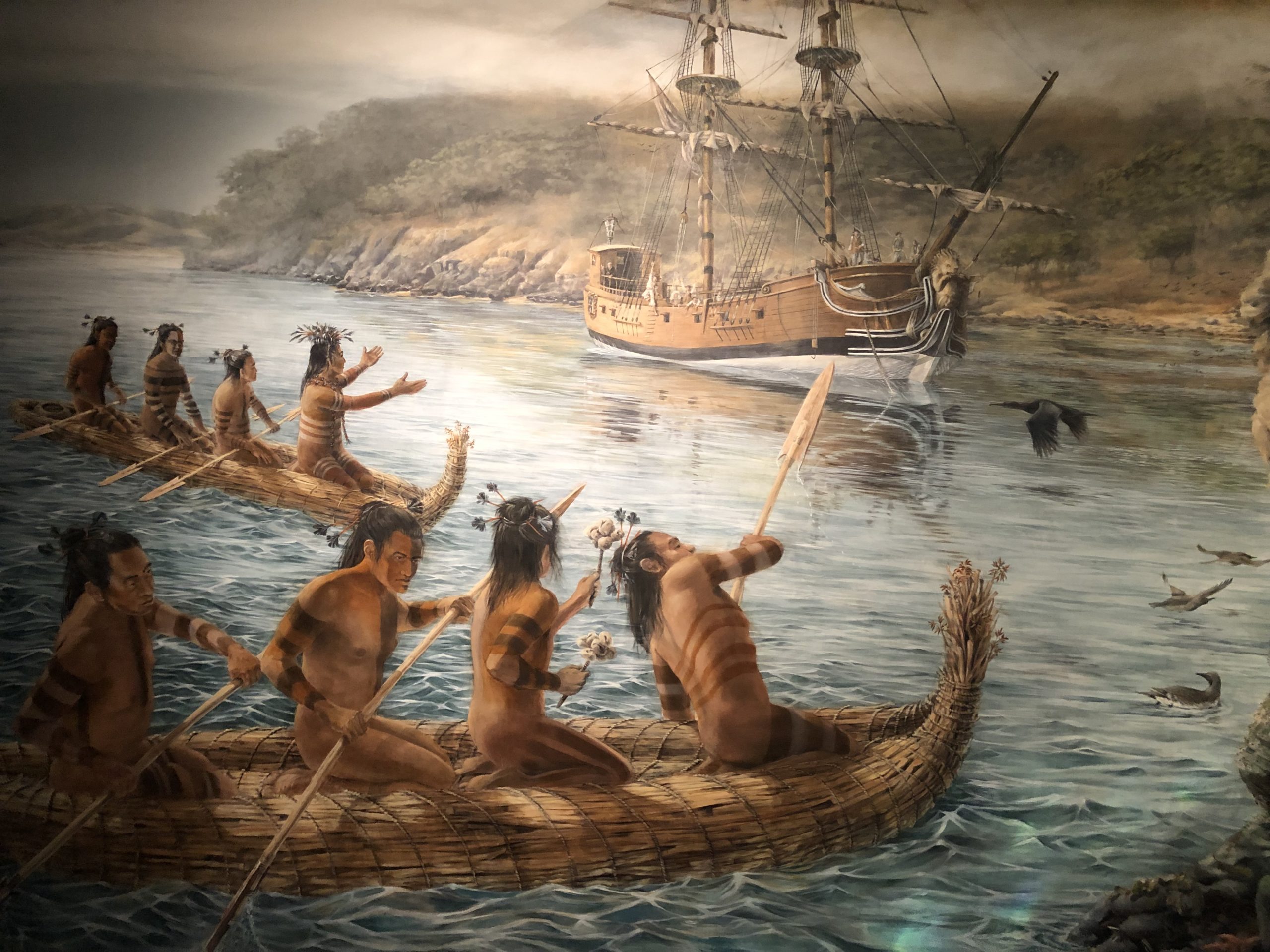 painting of Native Americans in canoes on display at the Maritime National Historical Park Visitor Center