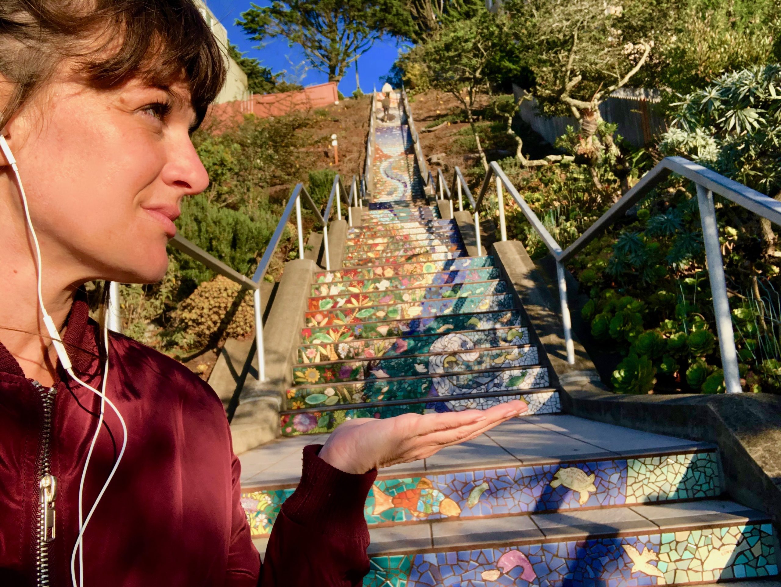 Tour guide posing for a photo with the tiled steps on 16th Ave