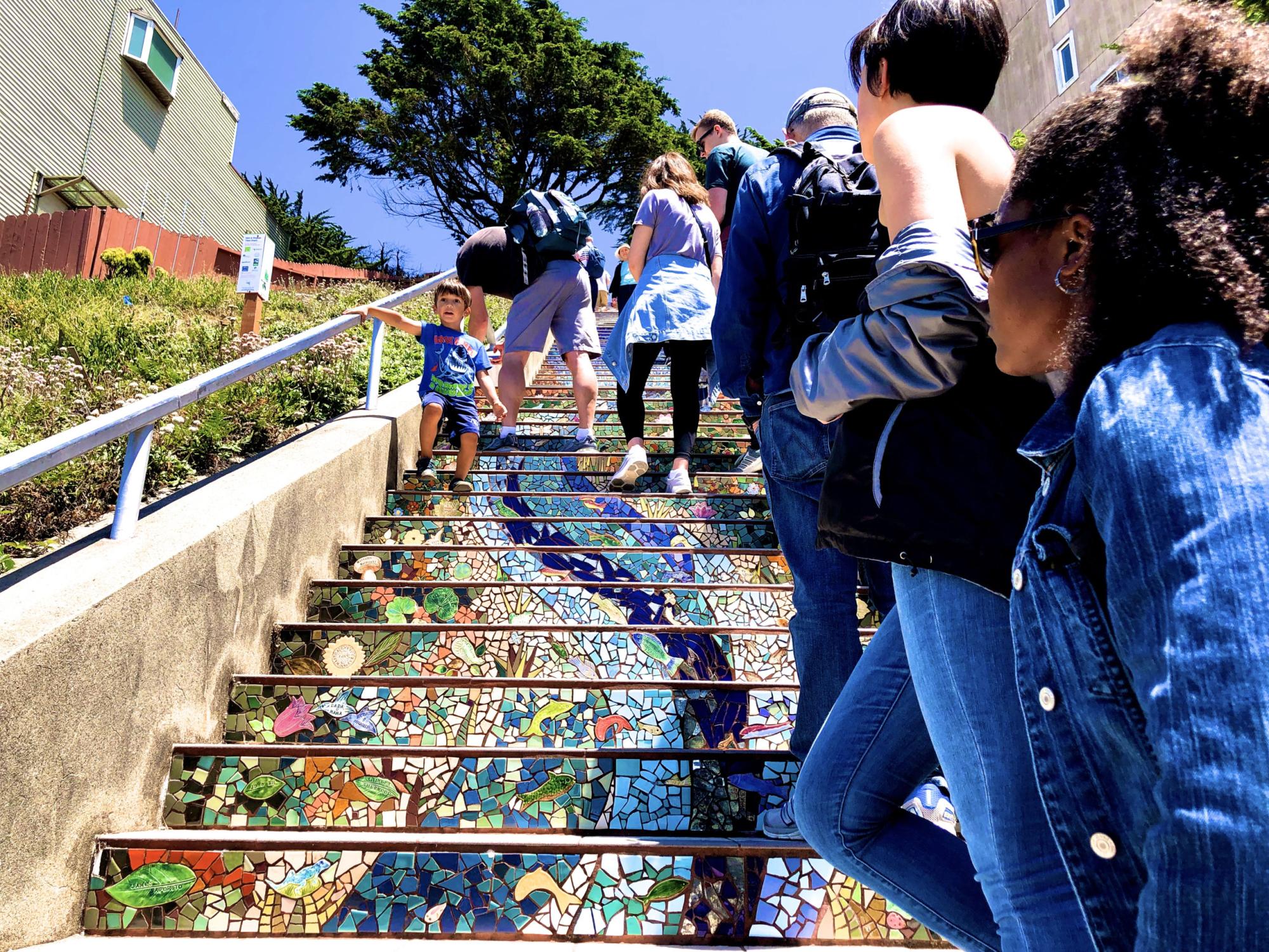 tour group climbing up 16th Avenue mosaic steps