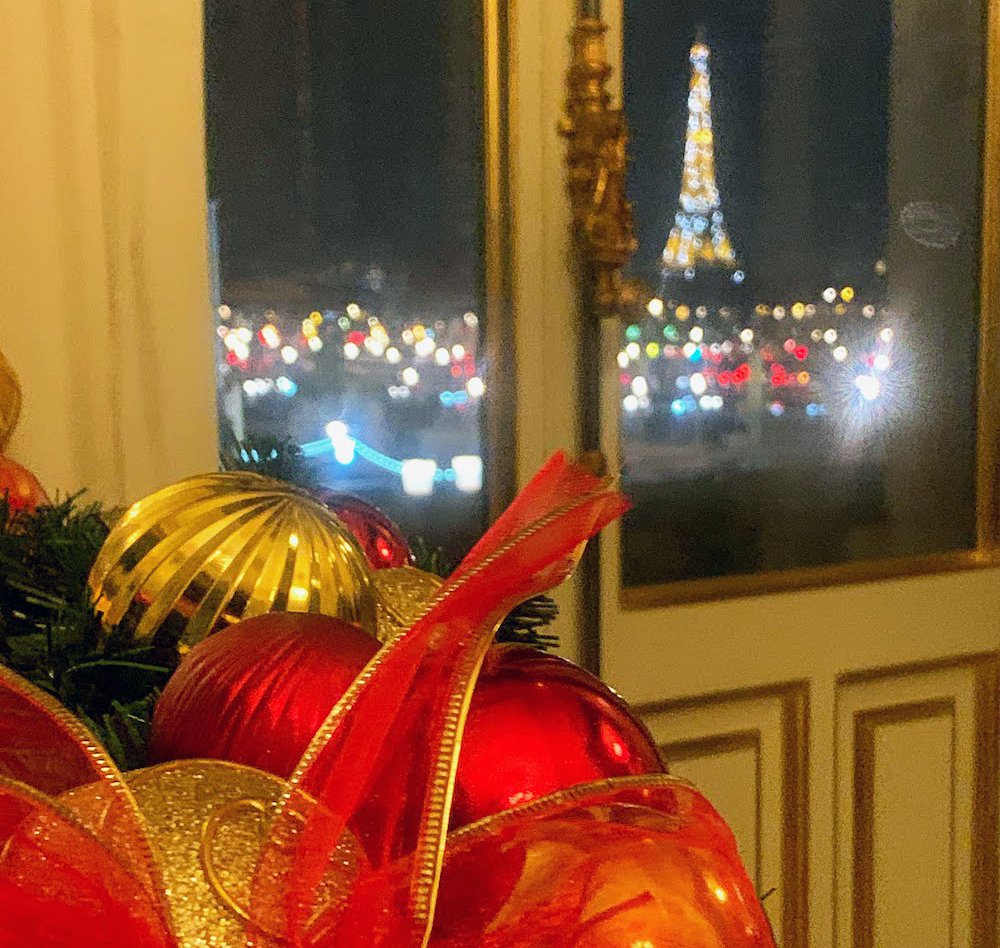 Christmas decor and dinner with a view of the sparkling Eiffel Tower at night in Paris