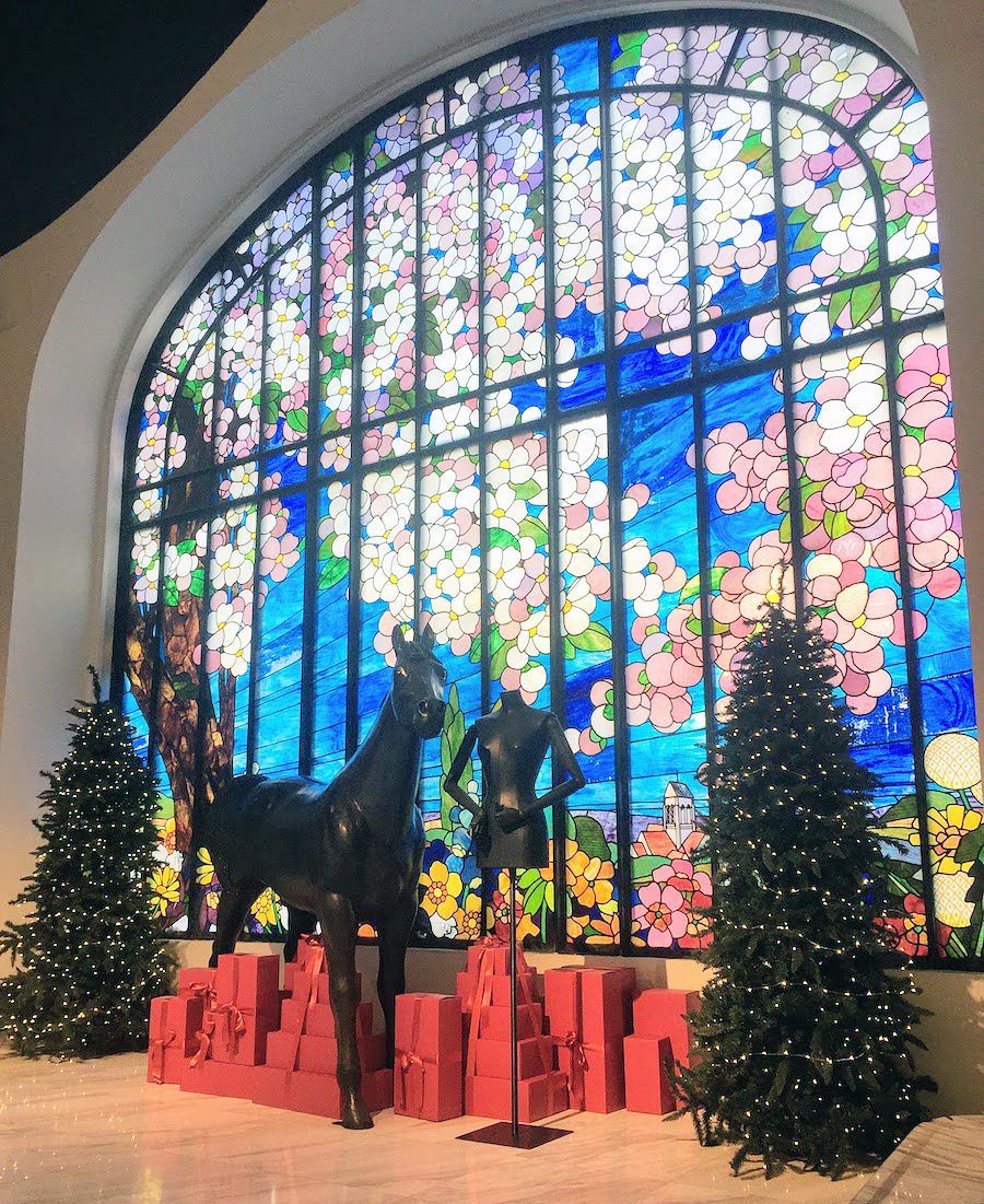 Stained glass in behind Christmas trees in Paris in December