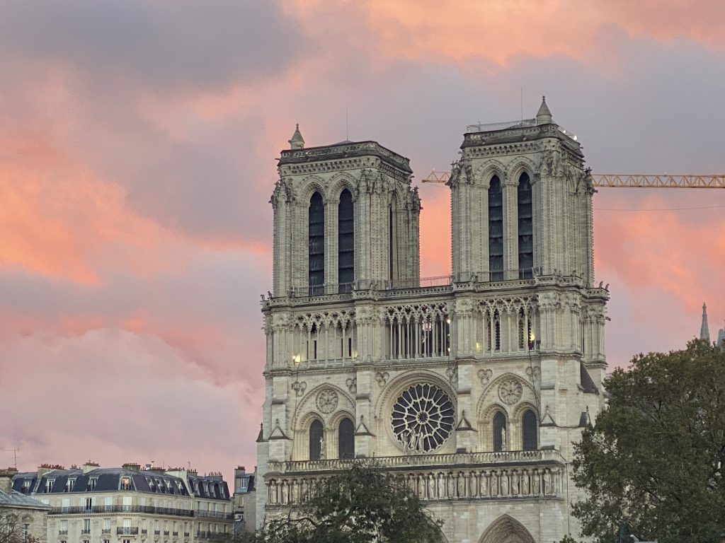 Notre Dame towers against a pink sky at sunset