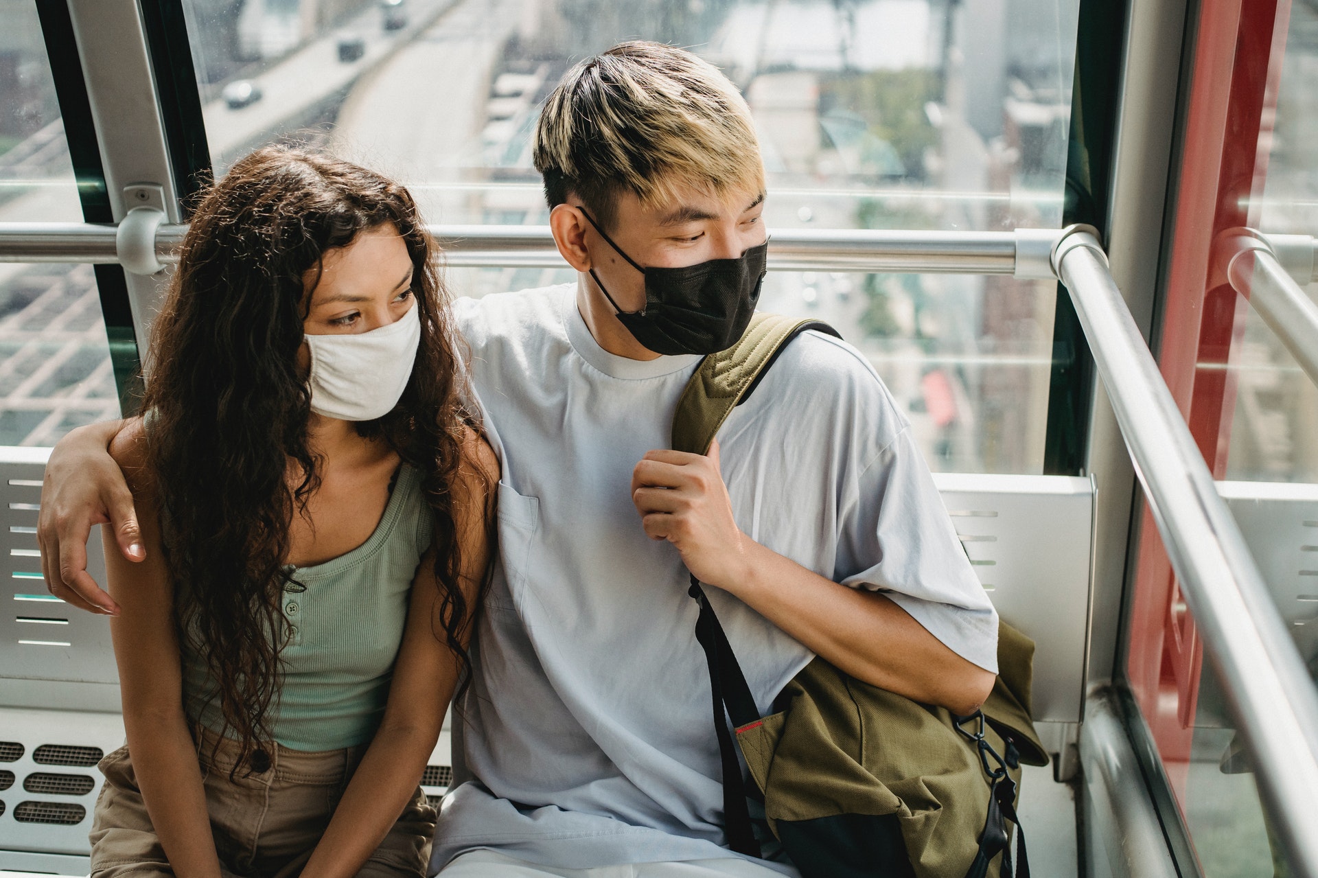 Couple hugging in masks during COVID