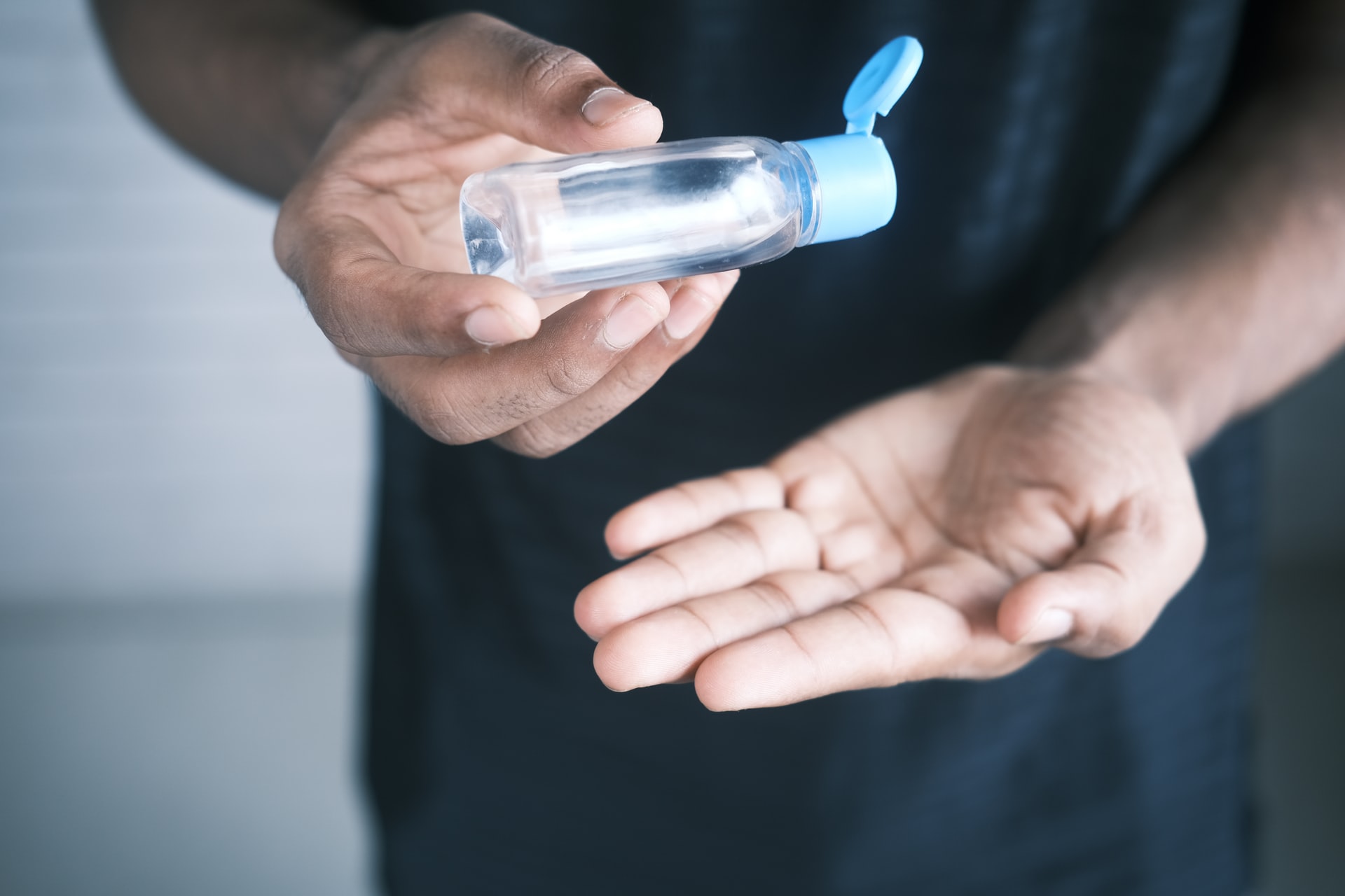 Man applies hand sanitizer during COVID