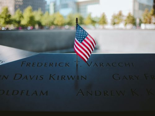 9/11 Memorial with American flag by fountain in NYC