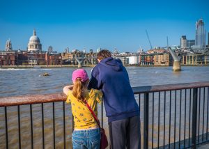 Teenage boy and his sister enjoying view of London, England, from South Bank of River Thames