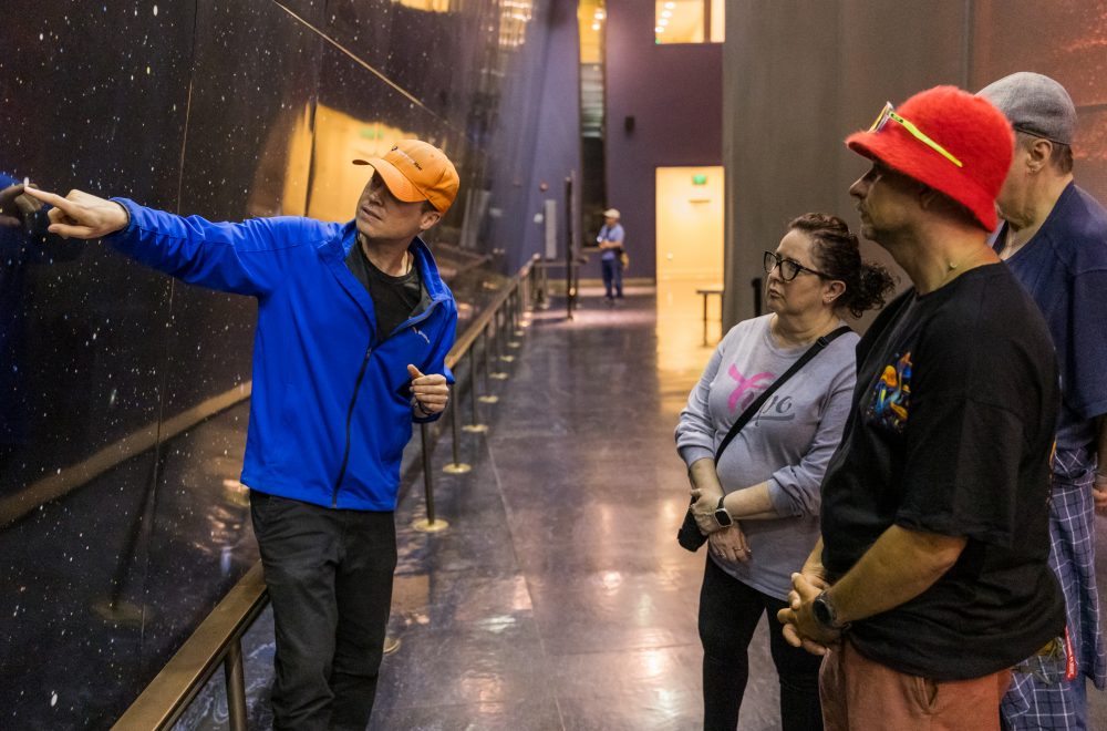 Tour Guide pointing inside Griffith Observatory