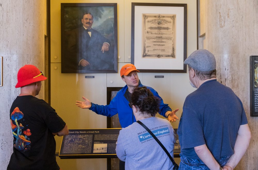 Vertical image of tour guide and guests inside Griffith Observatory