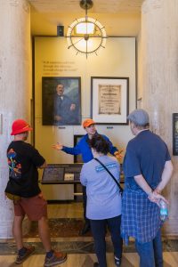 Vertical image of tour guide and guests inside Griffith Observatory