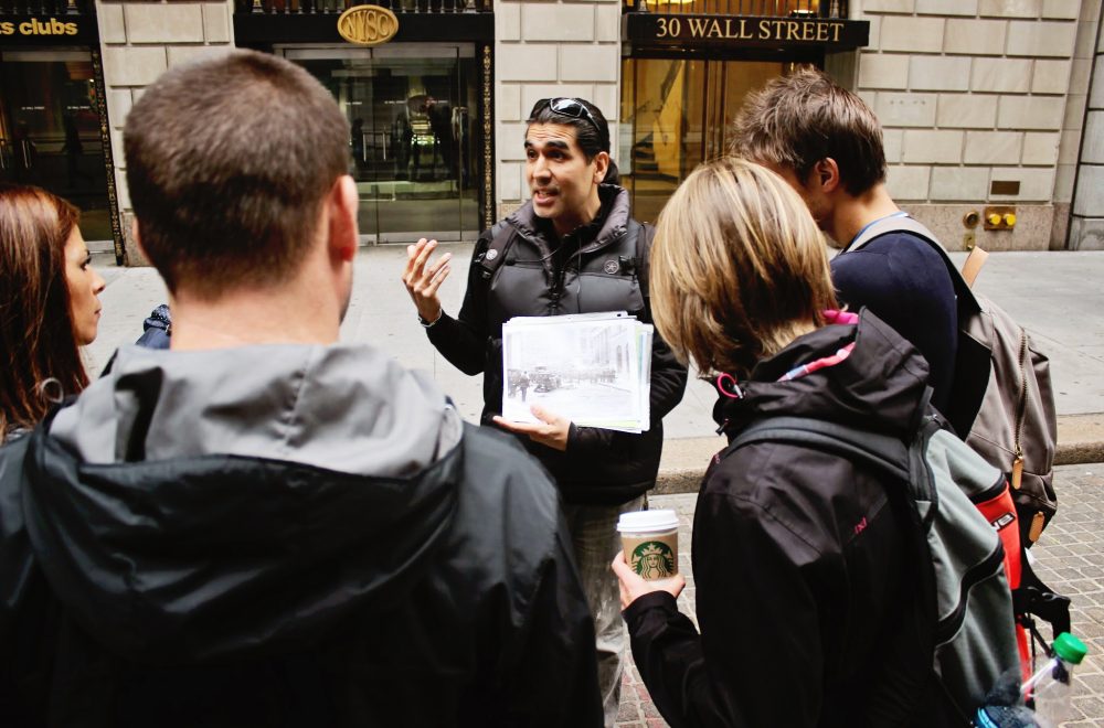 Wall Street tour guide with group