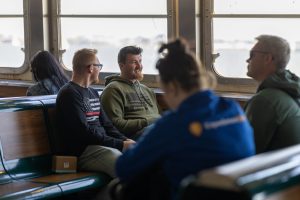 Tour Guide and guests on cruise during NYC in a Day tour