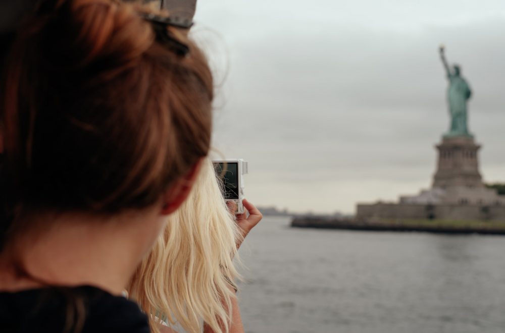 Tourists looking at Statue of Liberty from ferry