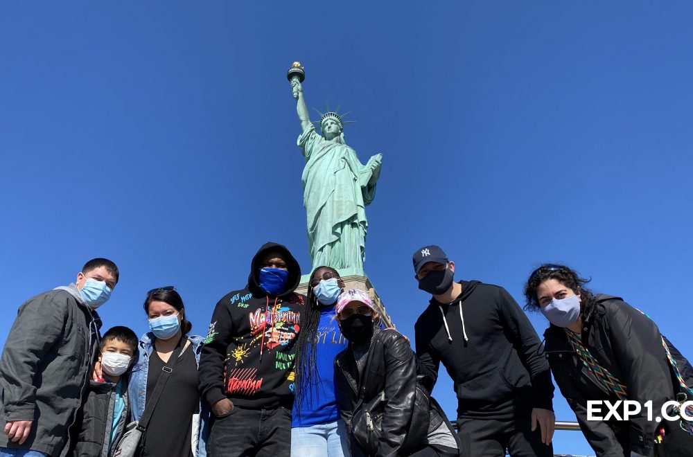 tour group at the statue of liberty on liberty island in new york