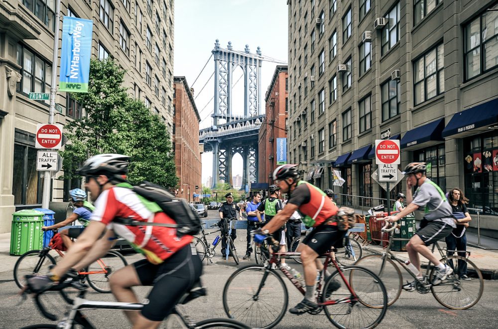 Cyclists in front of the Brooklyn Bridge