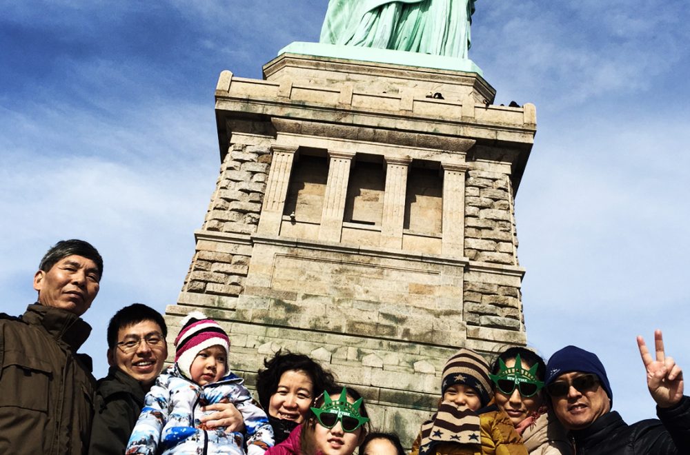 Family at Statue of Liberty on guided tour