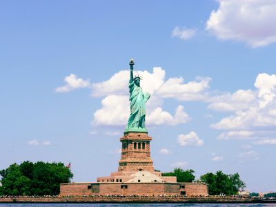 Tourists looking at Statue of Liberty from ferry