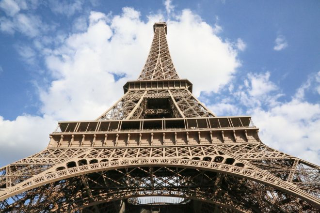 looking up at the summit of the Eiffel Tower