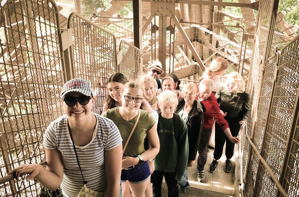 tour group climbing eiffel tower