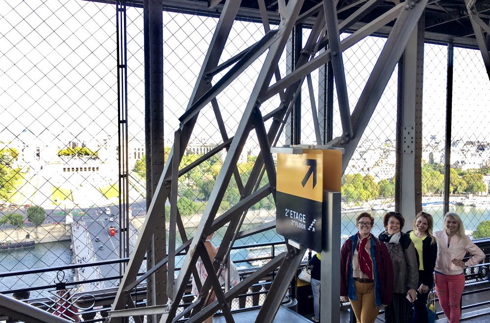 group climbing eiffel tower