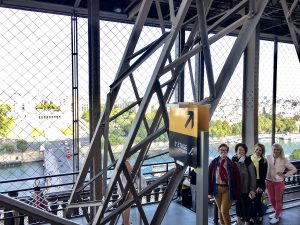 group climbing eiffel tower