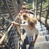 Eiffel Tower tour group with kids climbing to the second level of the tower