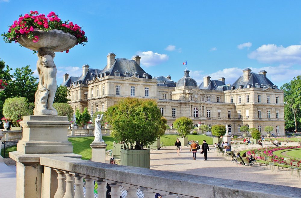 Luxembourg Gardens with cherubs holding flower pots in foreground and palace in the background