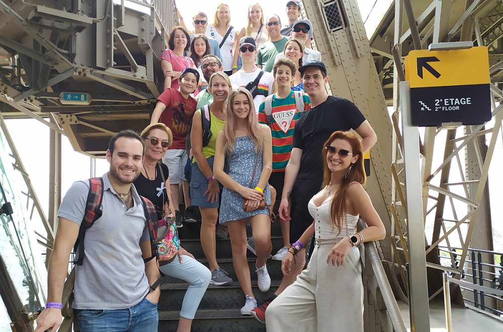 Tour group climbing Eiffel Tower in summer